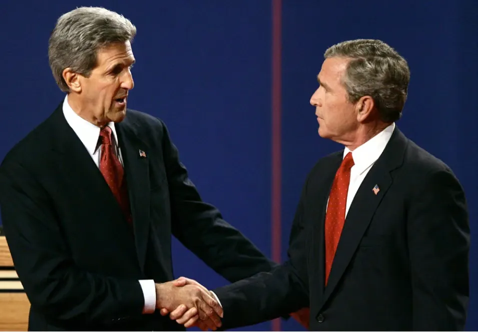 Two United States presidential candidates shaking hands at a televised debate